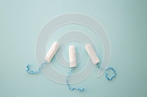 Menstrual tampon on a blue background top view. place for text.