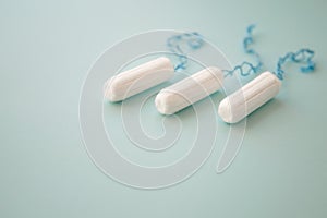 Menstrual tampon on a blue background top view. place for text.