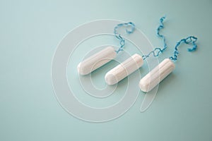 Menstrual tampon on a blue background top view. place for text.