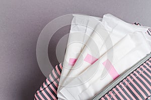 Menstrual tampons and pads in cosmetic bag. Menstruation time. Hygiene and protection