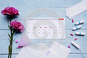 Menstruation calendar with pads, cup, and tampons