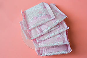 Menstruation, Wrapped pink period pads against pink background