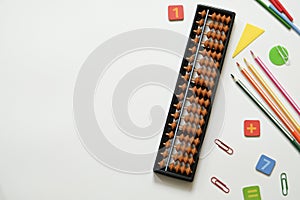 Mental arithmetic and Mathematics concept: colorful pens and pencils, numbers, abacus scores on white background, copy