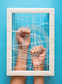 Mental health concept. Women`s hands try to break the fetters on blue background