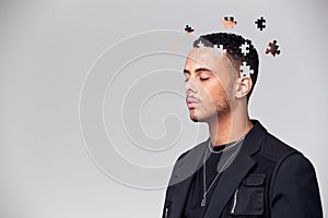 Mental Health Concept Of Young Man With Jigsaw Shaped Pieces Missing From Mind photo