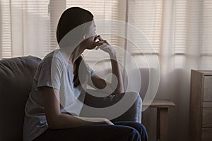 Mental health, depressed sad asian young woman, girl sitting on sofa, couch, expression to face difficulty, failure and exhausted