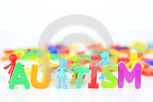 Mental health disorder, autism word with colored toys figurine on white background