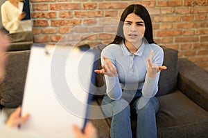 Mental health and psychological assistance concept. Teen indian lady having counseling session with psychotherapist