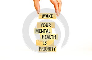 Mental health psychological symbol. Concept words Make your mental health a priority on wooden block. Beautiful white table white
