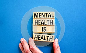 Mental health psychological symbol. Concept words Mental health is health on wooden blocks on a beautiful blue table blue