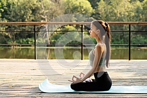 Mental health from stress, ptsd, neurosis, anxiety disorder, a woman meditates in a park near the water