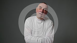 Mental illness in an elderly person on a gray background
