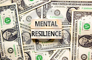 Mental resilience symbol. Concept word Mental resilience typed on wooden blocks. Beautiful background from dollar bills. Business