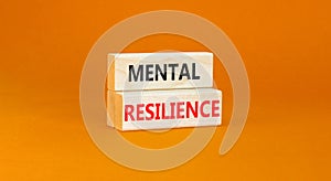 Mental resilience symbol. Concept word Mental resilience typed on wooden blocks. Beautiful orange table orange background.