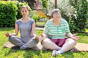 Mentally disabled woman and coach is doing yoga exercises