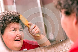 Mentally disabled woman combing through her hair