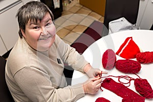 mentally disabled woman is crocheting, handiwork for a alternative therapy