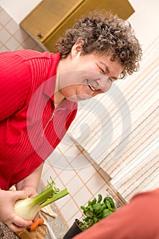 Mentally disabled woman in the kitchen is glad