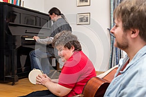 Mentally disabled woman learning a music instrument photo