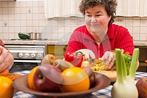 Mentally disabled woman learns cooking in the kitchen