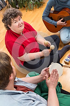 A mentally disabled woman playing a music instrument