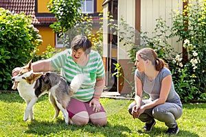 Mentally disabled woman with a second woman and a companion dog