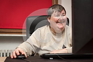 Mentally disabled woman sitting at the computer, Education and L