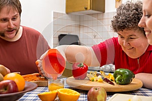 Mentally disabled woman and two caretakers cooking together