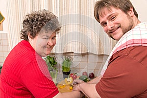 Mentally disabled woman and a young man cooking together