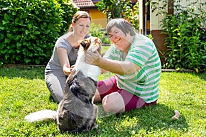 Mentally disabled woman with a second woman and a companion dog