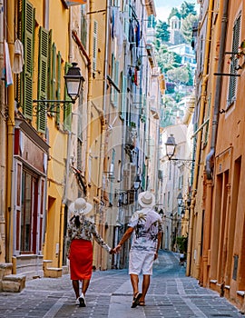 Menton France,couple men and woman on vacation at the Cote d Azur France, View on old part of Menton