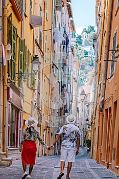 Menton France,couple men and woman on vacation at the Cote d Azur France, View on old part of Menton, Provence-Alpes