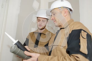 Mentor showing usage caulking to apprentice