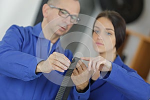 Mentor teaching female apprentice