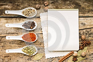Menu background. Recipe notepad with diveristy of spices and herb. photo