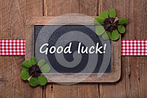 Menu board with clovers and good luck message with wood