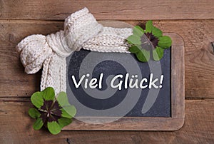 Menu board with good luck message in german - clovers and white