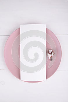 Menu card mockup with blooming almond branch on a pink plate