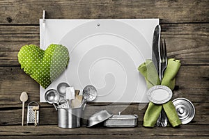 Menu card with old kitchen utensils, white placard, apple green