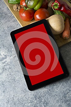 Menu Digital tablet with fresh vegetables