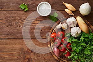 Menu, recipe, mock up, banner. Food seasoning background. Spices, Herbs and round wooden cutting board on brown dark wooden