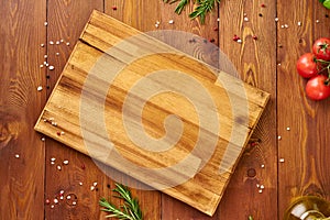 Menu, recipe, mock up, banner. Food seasoning background. Spices, Herbs and wooden cutting board on brown dark wooden backdrop.