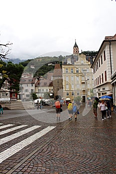 Merano, a street in the center with Porta Bolzano in the background, one of the four gates to the town