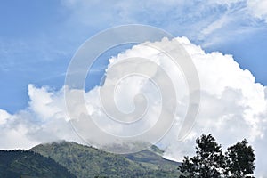 Merbabu mountain view with bright blue cloudy sky
