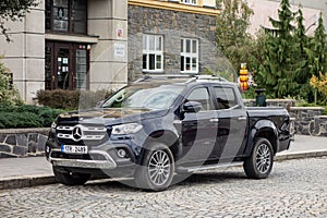 The Mercedes-Benz X Class pickup in front of the building. The vehicle was a big disappointment for German manufacturer and it is