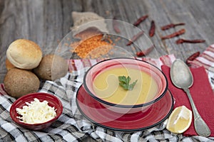 Mercimek corbasi, red lentil soup, turkish cuisine.  bowl of soup, parsley and croutons on wooden table