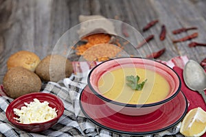 Mercimek corbasi, red lentil soup, turkish cuisine.  bowl of soup, parsley and croutons on wooden table