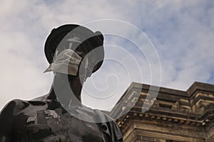 The Mercurial statue in Glasgow street has been turned into a symbol of the coronavirus covid 19 by wearing a protective mask.