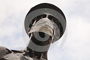 The Mercurial statue in Glasgow street has been turned into a symbol of the coronavirus covid 19 by wearing a protective mask.