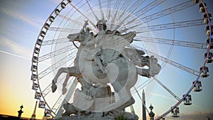 Mercury riding Pegasus statue and giant Ferris wheel in Tuileries Garden, Paris